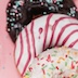 3 various donuts on pink background